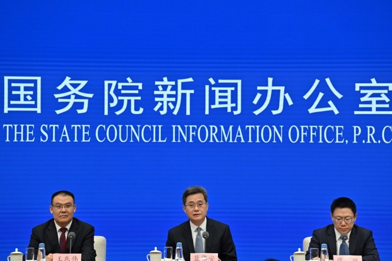 China’s Finance Minister Lan Fo’an (C) speaks next to Vice Minister of Finance Wang Dongwei (L) and Vice Minister of Finance Liao Min (R) during a press conference in Beijing on October 12, 2024.