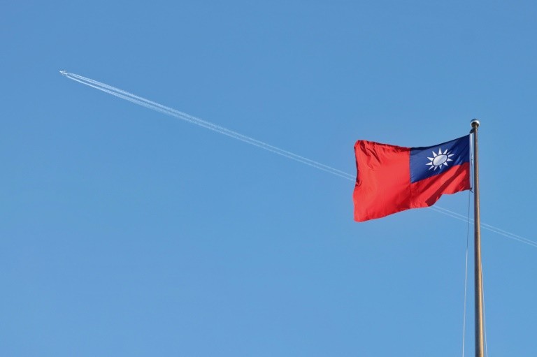 A Taiwan flag flies over the capital, Taipei, in October 2024. The self-ruled island is closely watching the US election for signs of policy shifts that could impact tensions with China