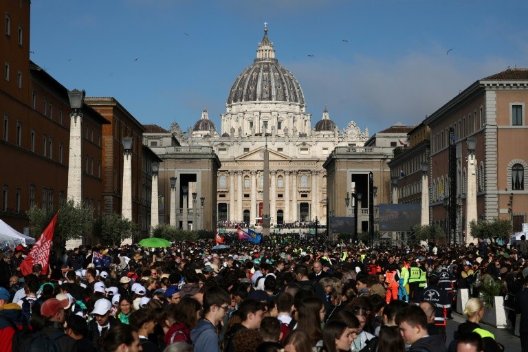 People gather along Via della Conciliazione street ahead of late Pope Francis' funeral ceremony