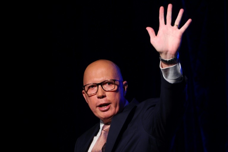 Australia's Opposition Leader Peter Dutton waves after conceding defeat in Australia's general election.