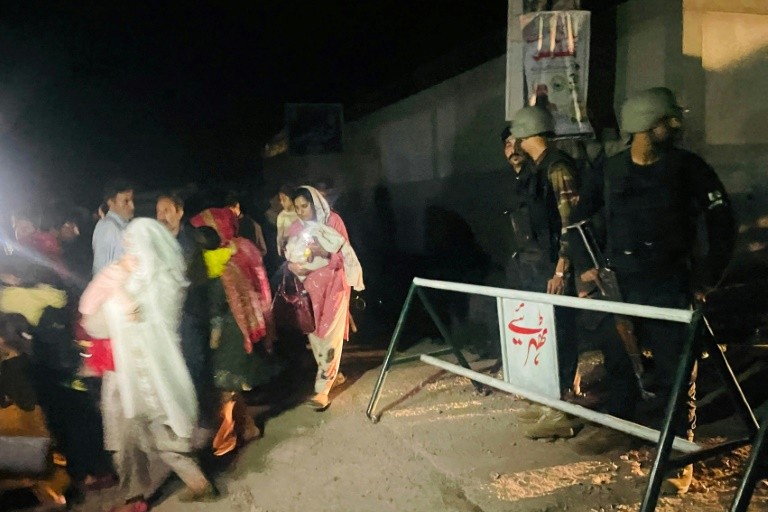 Security personnel cordon-off a street as local residents evacuate their homes near the site of a strike in Muzaffarabad, the capital of Pakistan-administered Kashmir, on May 7, 2025