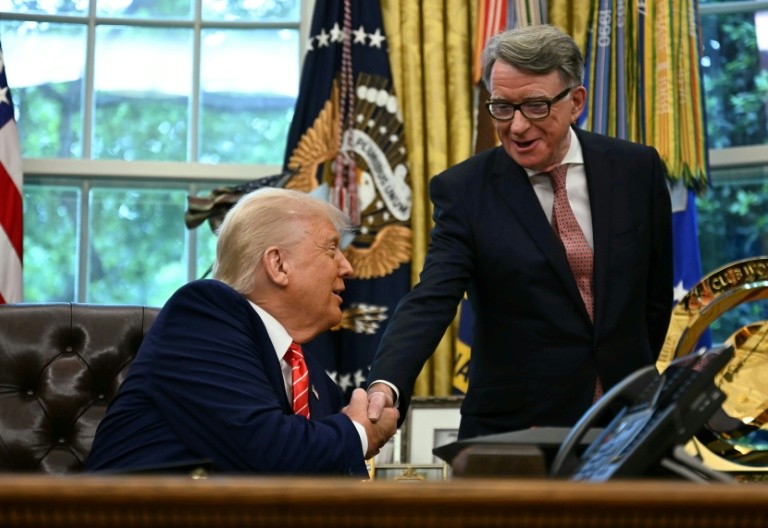 US automakers are critical of a new trade deal that favors British automakers, which was announced with a press event with US President Donald Trump shaking hands with British ambassador to the United States Peter Mandelson at the White House
