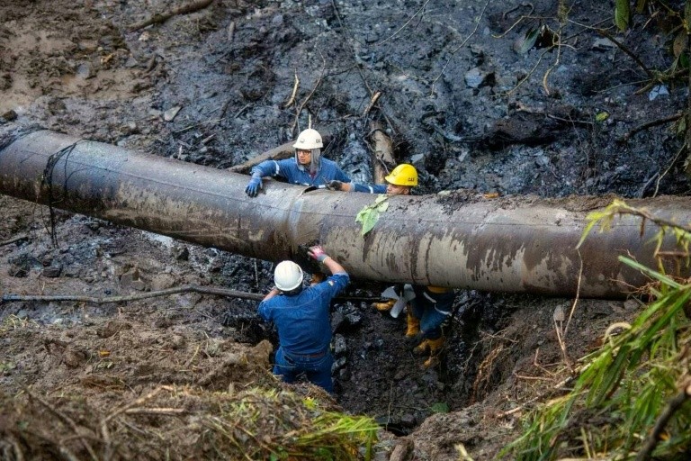 Handout picture released by the State Petroleum Company of Ecuador (EP Petroecuador) showing workers repairing a pipeline in El Reventador, Sucumbios province, Ecuador, on June 16, 2025.