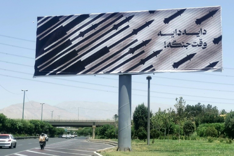 Commuters drive past an anti-Israel billboard in Tehran
