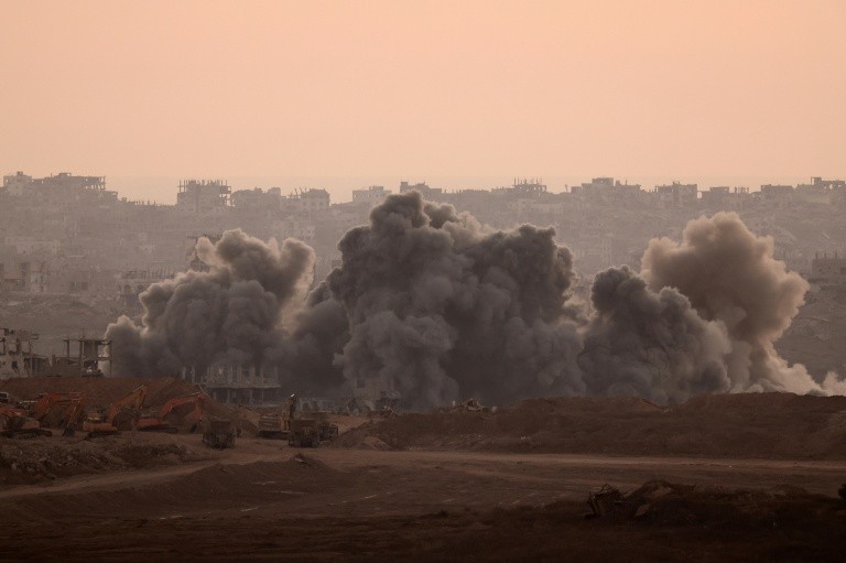 A picture taken from a position at Israel's border with the Gaza Strip shows smoke billowing during an Israeli strike on the besieged Palestinian territory on July 8, 2025