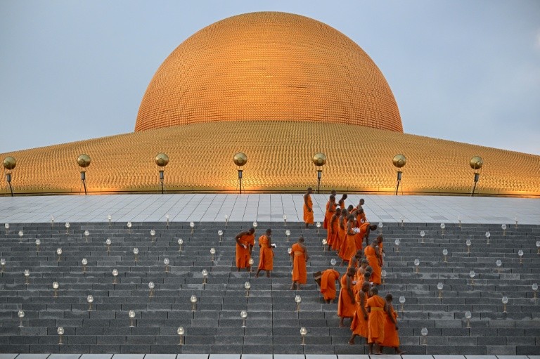 Buddhist monks turn on electric candles during celebrations at Wat Dhammakaya temple in Pathum Thani. Thai men are traditionally expected to ordain as monks at least once in their lives for a period lasting as short as a few weeks or as long as decades