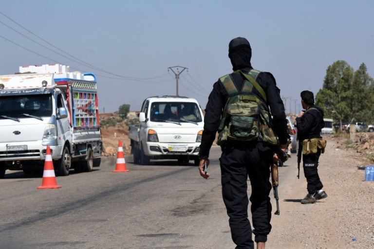 Syrian security forces man a checkpoint to prevent fighters from other parts of the country joining the fighting in Sweida after the government ordered an immediate ceasefire.