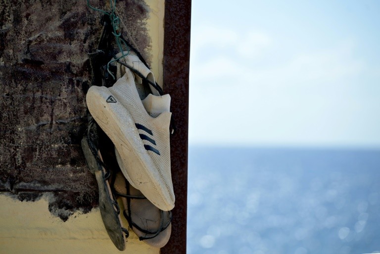 Shoes hanging on the "Porta di Lampedusa" monument, known as "The door of Europe", dedicated to the migrants who have died in the Mediterranean sea trying to reach Europe, on September 25, 2023 on the Italian island of Lampedusa