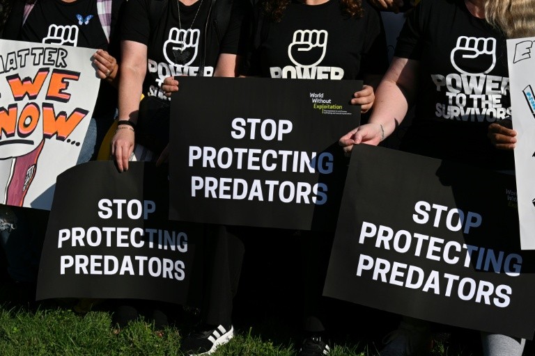 Demonstrators at a "Stand with Survivors" rally in support of victims of Jeffrey Epstein