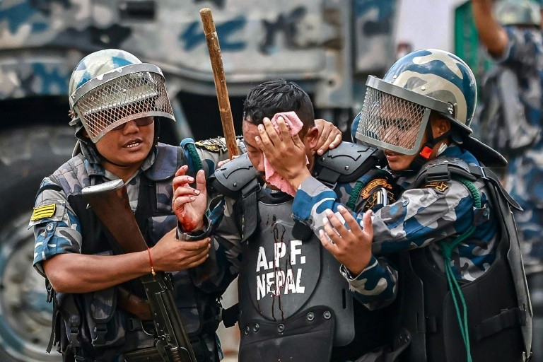 Nepal's Armed Police Force personnel carry an injured comrade