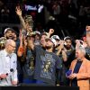 Jalen Brunson hoists the NBA Finals MVP trophy