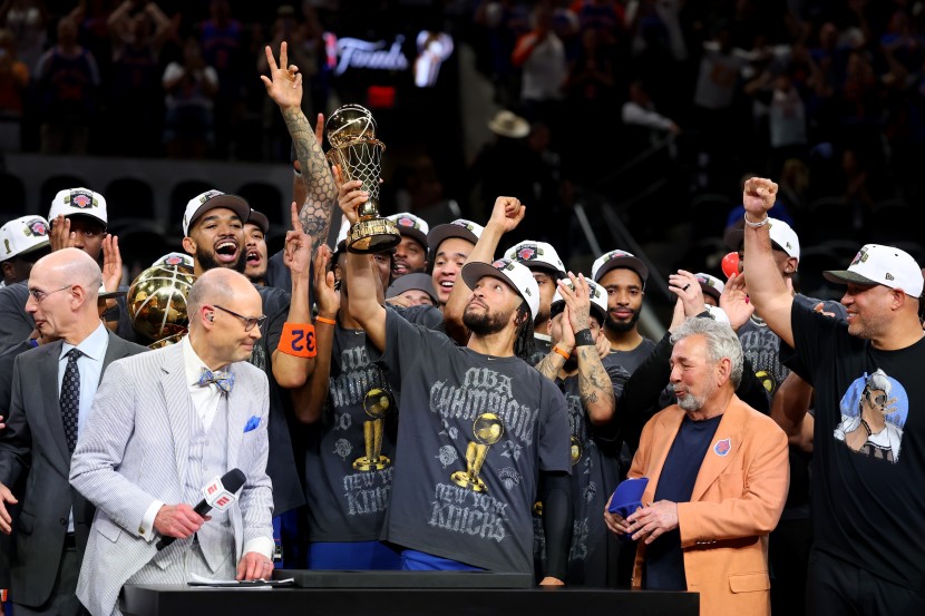 Jalen Brunson hoists the NBA Finals MVP trophy